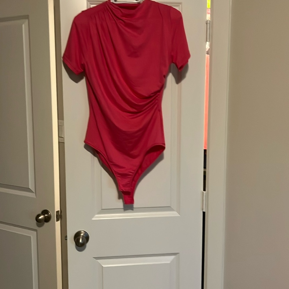 Coral bodysuit figure flattering.  No tags, but never worn.
